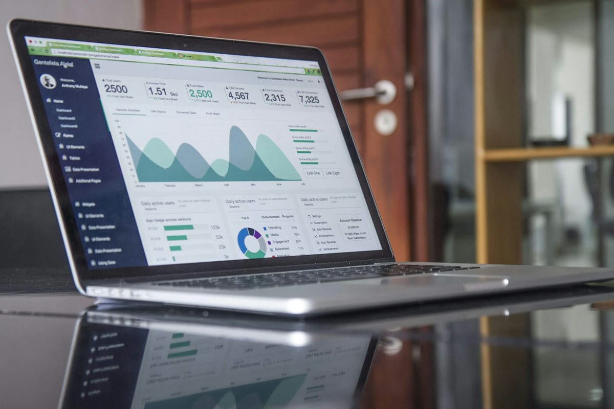 Financial analysis workspace with a laptop and reports